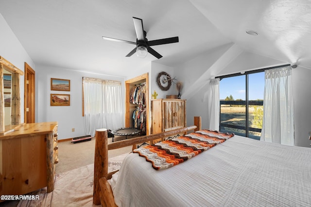 bedroom featuring a closet, ceiling fan, carpet, access to exterior, and lofted ceiling