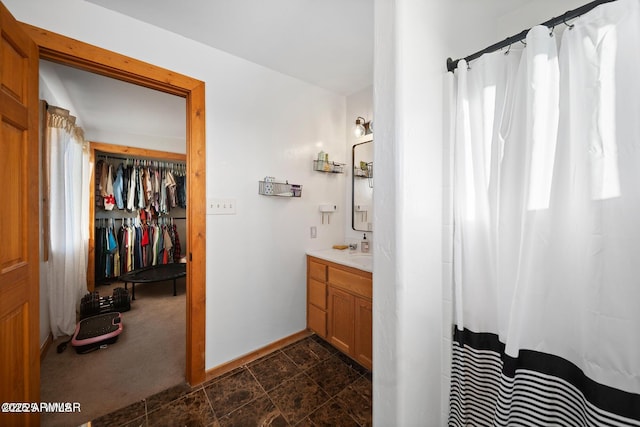 full bathroom with baseboards, vanity, and a shower with curtain