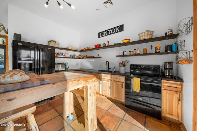 kitchen with visible vents, open shelves, a sink, dark countertops, and black appliances