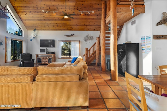 living room featuring a ceiling fan, visible vents, wood ceiling, stairs, and tile patterned floors