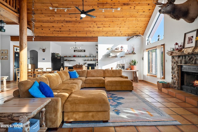 living area featuring high vaulted ceiling, tile patterned flooring, wood ceiling, and track lighting