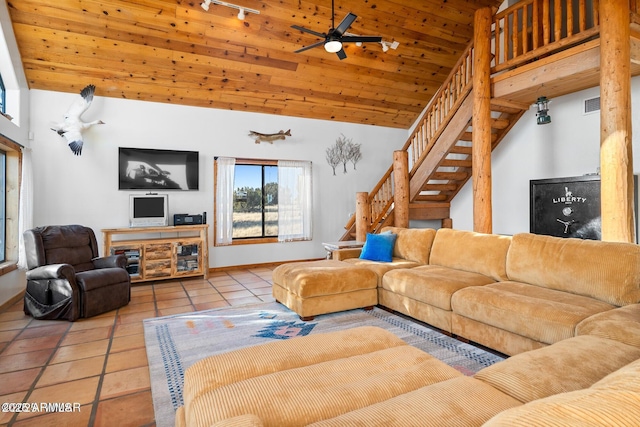 living room with tile patterned flooring, stairway, visible vents, lofted ceiling, and ceiling fan