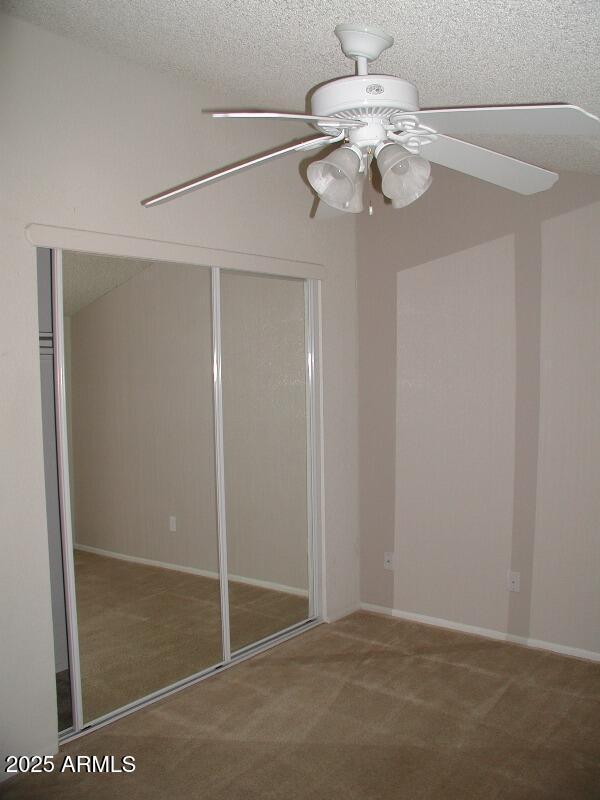 unfurnished bedroom featuring carpet floors, a closet, and a textured ceiling