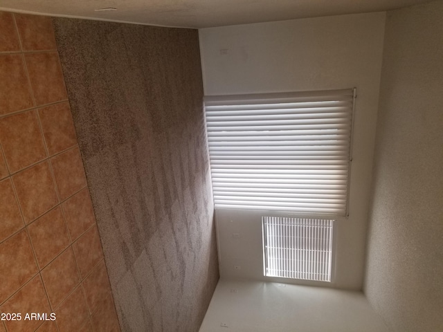 unfurnished room featuring visible vents