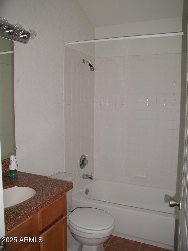 bathroom with shower / bath combination, vanity, tile patterned floors, and toilet