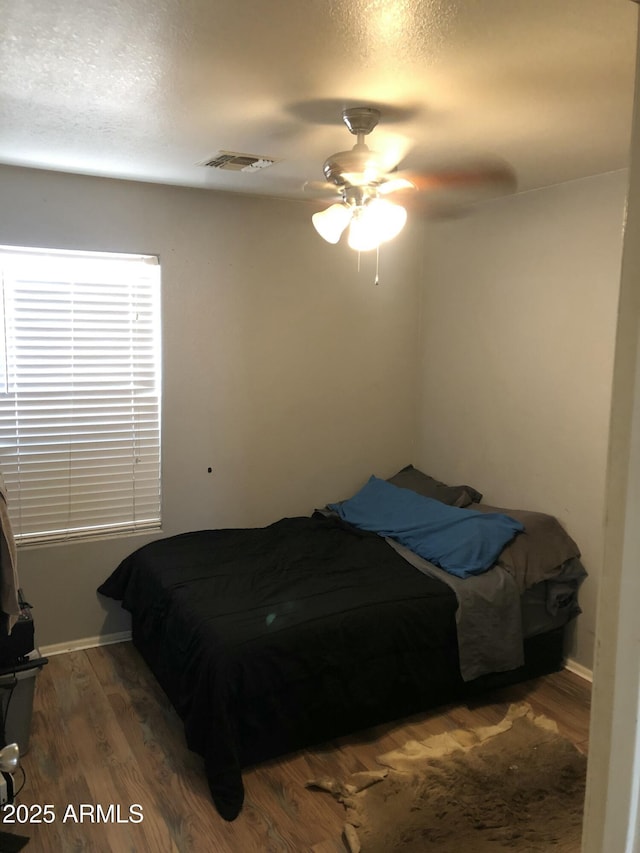 16120 W Kendall St, Goodyear, AZ 85338 - bedroom featuring baseboards, a textured ceiling, visible vents, a ceiling fan, and wood finished floors