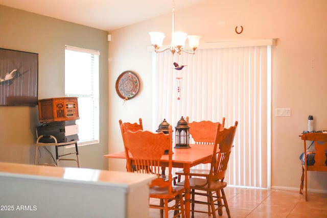 dining room with light tile patterned floors, plenty of natural light, and a chandelier