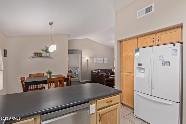 kitchen with stainless steel dishwasher, light brown cabinets, white refrigerator with ice dispenser, vaulted ceiling, and light tile patterned floors