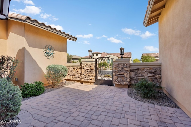 view of patio with a gate