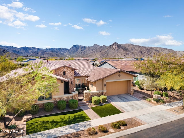 view of front of home with a mountain view, a garage, a tile roof, stucco siding, and driveway