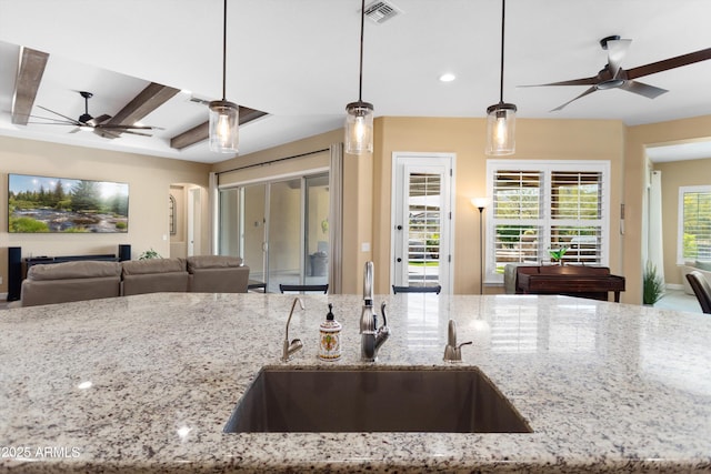 kitchen with visible vents, a sink, open floor plan, a ceiling fan, and recessed lighting