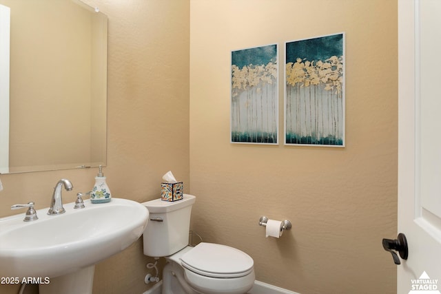 half bathroom with a sink and toilet