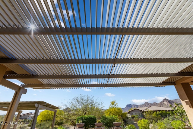 view of patio / terrace with a mountain view and fence