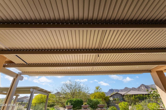 details with a mountain view and fence