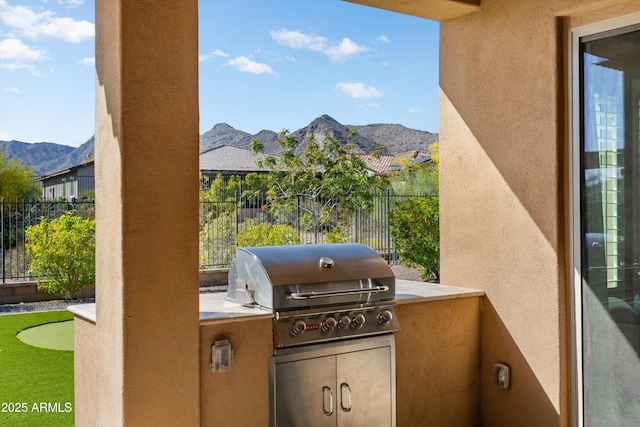view of patio / terrace featuring a mountain view, fence, a grill, and area for grilling