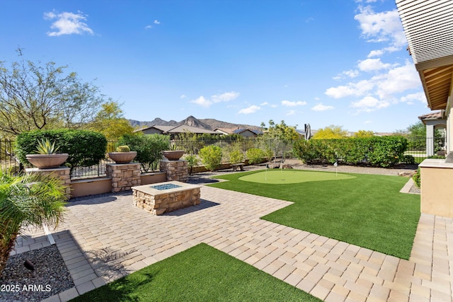 view of yard with an outdoor fire pit, fence, and a patio
