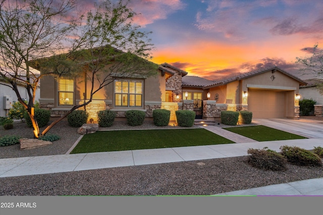 view of front facade featuring stucco siding, driveway, stone siding, a front yard, and a garage