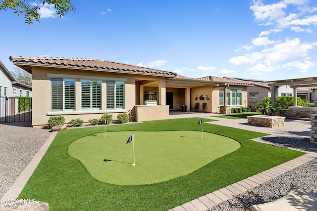 back of house with a tiled roof, an outdoor fire pit, fence, a patio, and stucco siding