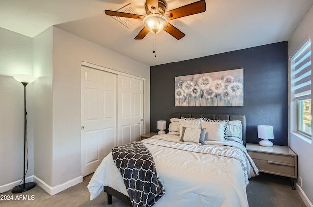 carpeted bedroom featuring ceiling fan and a closet