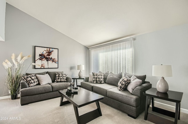 carpeted living room featuring lofted ceiling