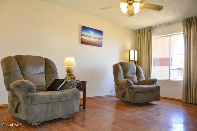 3519 W Libby St, Glendale, AZ 85308 - sitting room featuring a textured ceiling, ceiling fan, baseboards, and wood finished floors