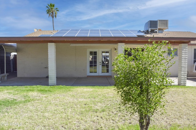 3519 W Libby St, Glendale, AZ 85308 - back of property featuring french doors, solar panels, and a lawn
