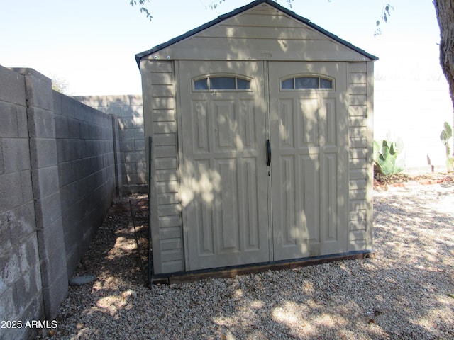 view of shed with a fenced backyard