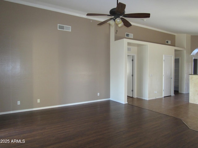 unfurnished room featuring dark wood-style floors, visible vents, and ornamental molding