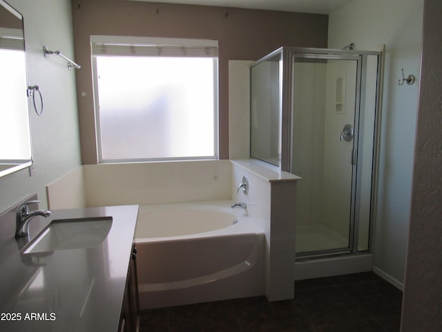 bathroom with a stall shower, tile patterned floors, vanity, and a bath