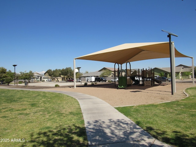 view of property's community featuring playground community and a lawn