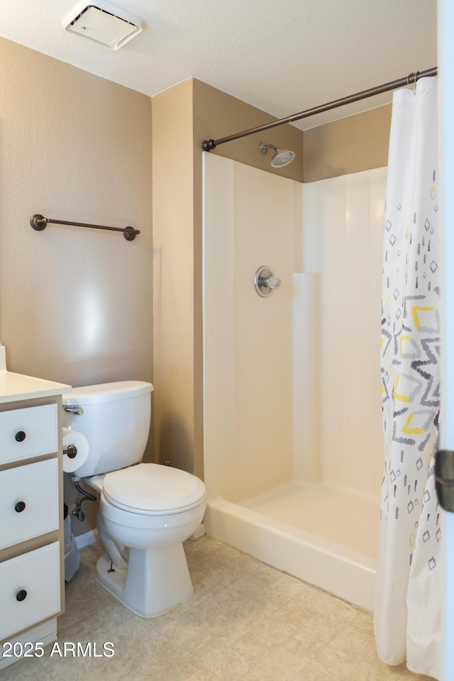 bathroom with vanity, a shower with curtain, and toilet