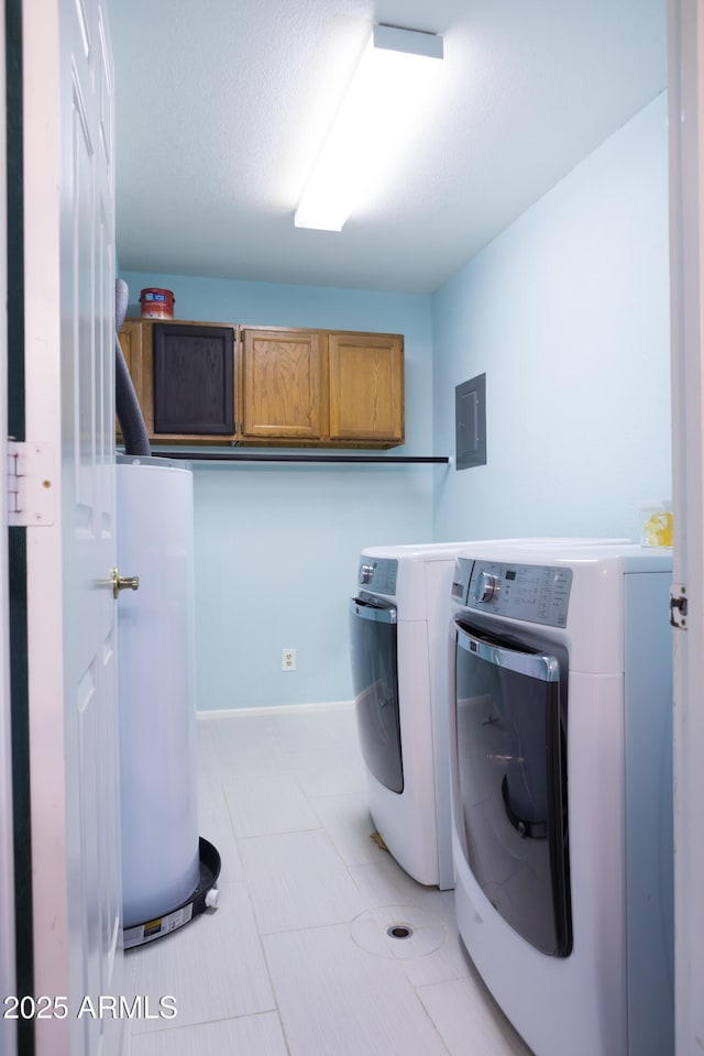 clothes washing area featuring cabinets, light tile patterned flooring, separate washer and dryer, and electric panel