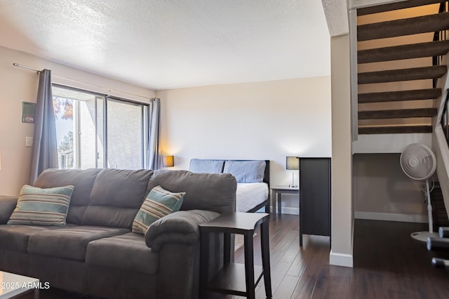 bedroom featuring dark hardwood / wood-style floors and a textured ceiling