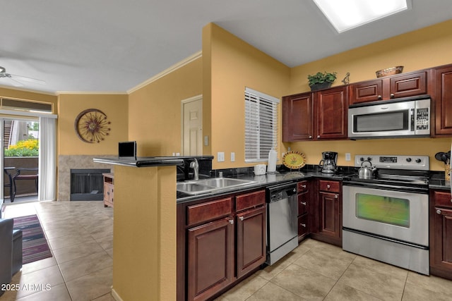 5335 E Shea Blvd Unit 1094, Scottsdale, AZ 85254 - kitchen with appliances with stainless steel finishes, dark countertops, a sink, light tile patterned floors, and a tiled fireplace