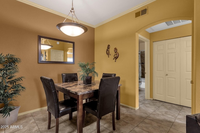 5335 E Shea Blvd Unit 1094, Scottsdale, AZ 85254 - dining room with arched walkways, crown molding, tile patterned flooring, and baseboards