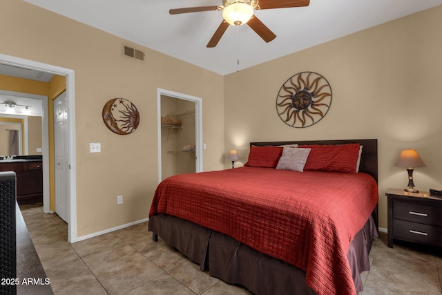 5335 E Shea Blvd Unit 1094, Scottsdale, AZ 85254 - bedroom featuring light tile patterned floors, a spacious closet, a sink, ceiling fan, and baseboards