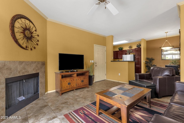 5335 E Shea Blvd Unit 1094, Scottsdale, AZ 85254 - living room featuring ceiling fan, crown molding, baseboards, a tiled fireplace, and light tile patterned floors