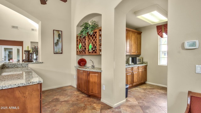 5335 E Shea Blvd Unit 1094, Scottsdale, AZ 85254 - bar with a sink, ceiling fan, stainless steel microwave, and baseboards