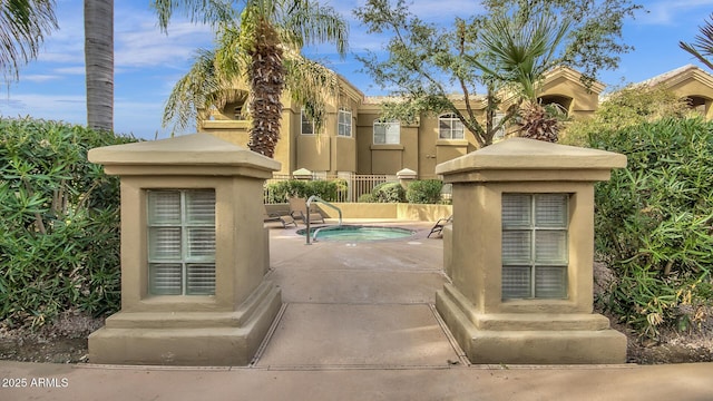 5335 E Shea Blvd Unit 1094, Scottsdale, AZ 85254 - view of front of home with stucco siding, a community hot tub, and a patio area