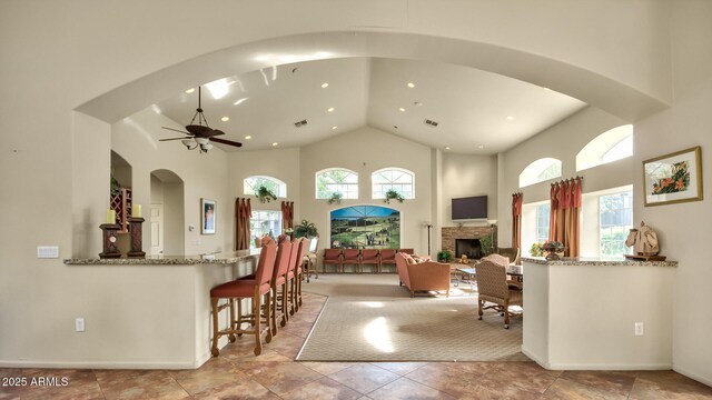5335 E Shea Blvd Unit 1094, Scottsdale, AZ 85254 - living area featuring high vaulted ceiling, plenty of natural light, a ceiling fan, recessed lighting, and arched walkways