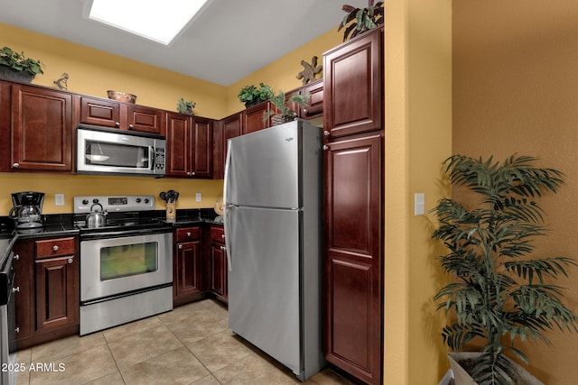 5335 E Shea Blvd Unit 1094, Scottsdale, AZ 85254 - kitchen with stainless steel appliances, dark countertops, light tile patterned floors, and dark brown cabinets