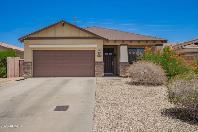 205 N 107th Dr, Avondale, AZ 85323 - view of front facade with driveway, stone siding, a garage, and board and batten siding