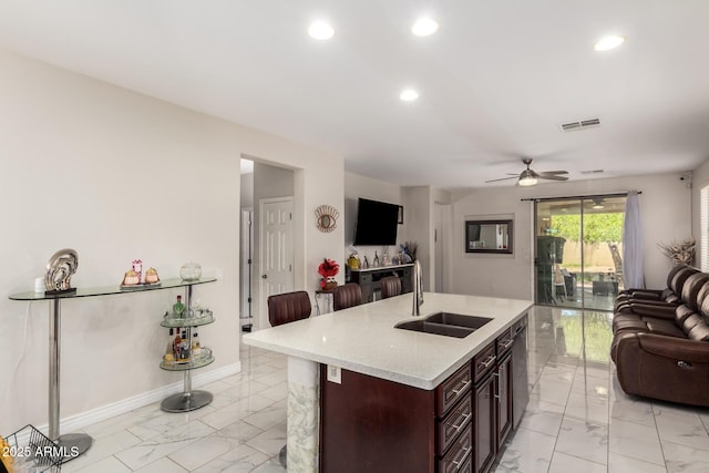 205 N 107th Dr, Avondale, AZ 85323 - kitchen featuring open floor plan, light marble finish floors, recessed lighting, a ceiling fan, and a center island with sink