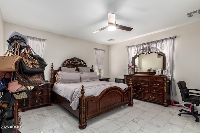 205 N 107th Dr, Avondale, AZ 85323 - bedroom with light marble finish flooring, multiple windows, and ceiling fan