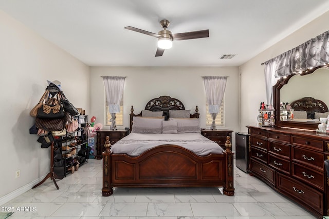205 N 107th Dr, Avondale, AZ 85323 - bedroom with light marble finish flooring, multiple windows, and ceiling fan