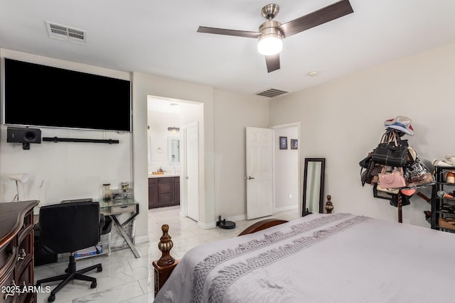 205 N 107th Dr, Avondale, AZ 85323 - bedroom with light marble finish flooring, ensuite bath, a desk, and ceiling fan