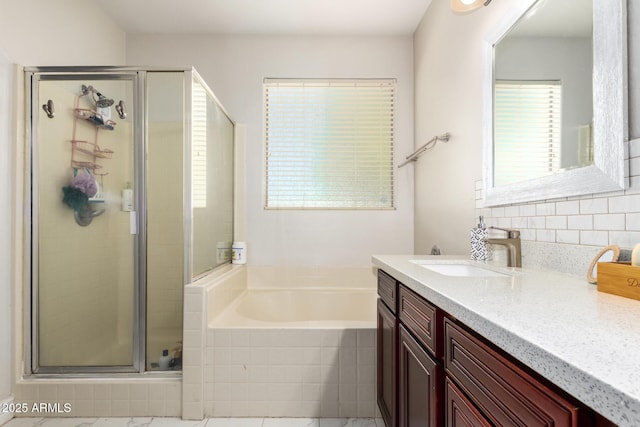 205 N 107th Dr, Avondale, AZ 85323 - full bathroom featuring vanity, a garden tub, a stall shower, and backsplash