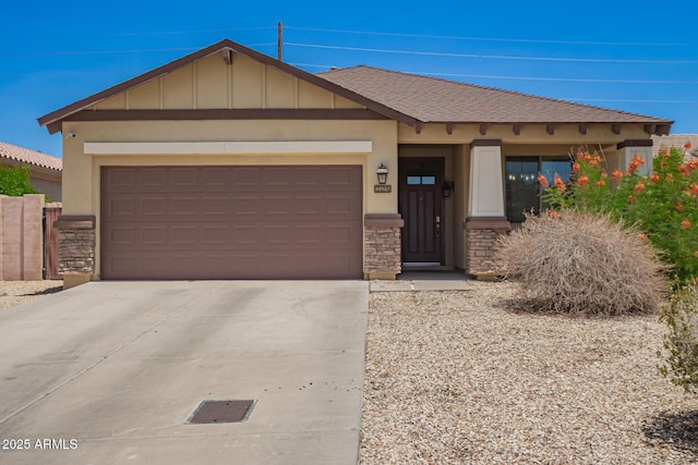 205 N 107th Dr, Avondale, AZ 85323 - view of front of house with driveway, a garage, stone siding, board and batten siding, and stucco siding