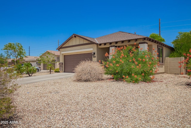 205 N 107th Dr, Avondale, AZ 85323 - view of front facade featuring an attached garage, stucco siding, concrete driveway, and board and batten siding