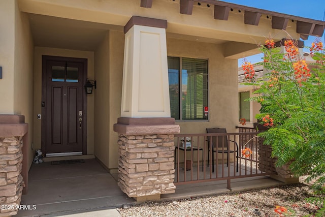 205 N 107th Dr, Avondale, AZ 85323 - view of exterior entry with stucco siding and a porch